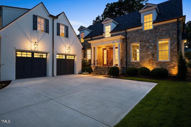 1307 Mayfair Rd, Raleigh, NC 27608 - view of front of home with an attached garage, concrete driveway, stone siding, and a front lawn