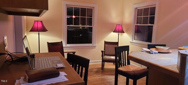 office area with baseboards and wood finished floors