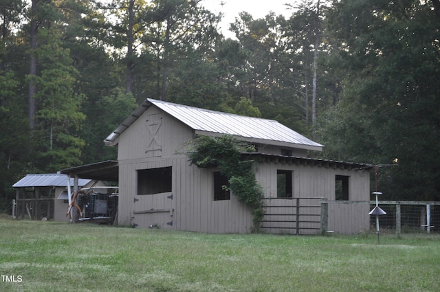 view of outbuilding with an outdoor structure and fence