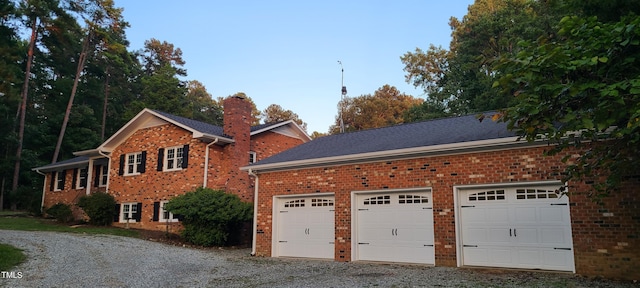 view of property exterior featuring brick siding, a chimney, and roof with shingles