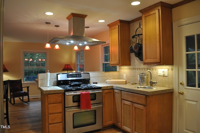 kitchen with dark hardwood / wood-style floors, sink, island exhaust hood, hanging light fixtures, and double oven range