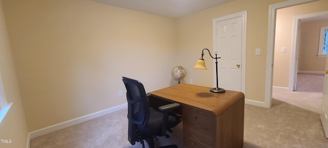 office space with light carpet and baseboards