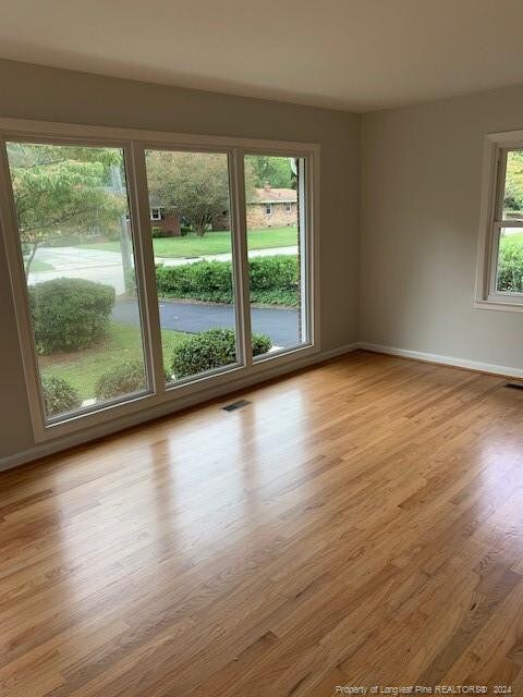 spare room with light wood-type flooring