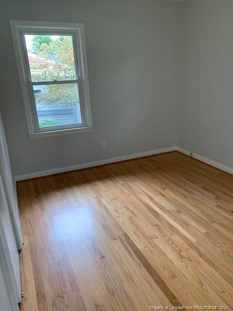 unfurnished room featuring light hardwood / wood-style floors