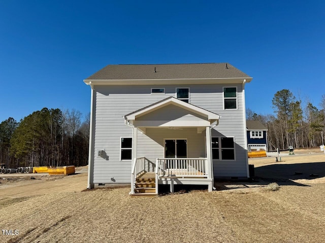 rear view of property featuring covered porch