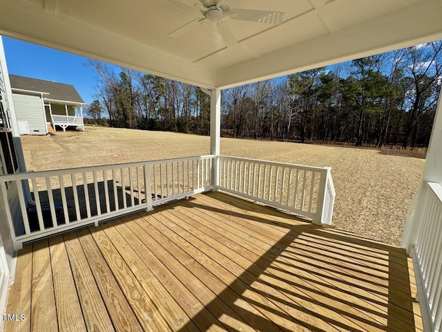 wooden deck with a ceiling fan