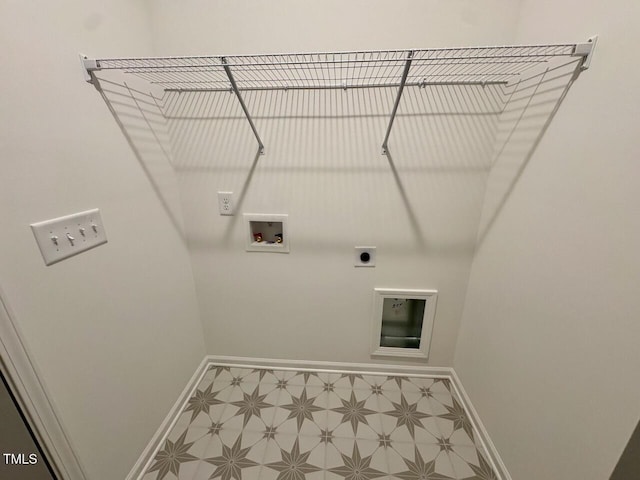 clothes washing area with hookup for a washing machine, laundry area, baseboards, and tile patterned floors