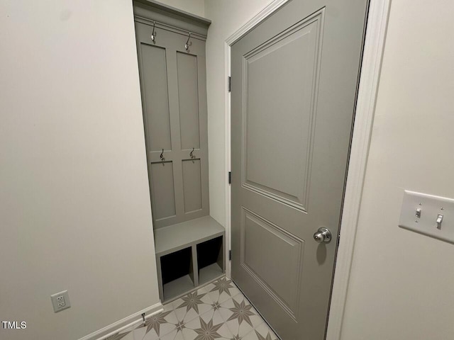 mudroom with light floors and baseboards