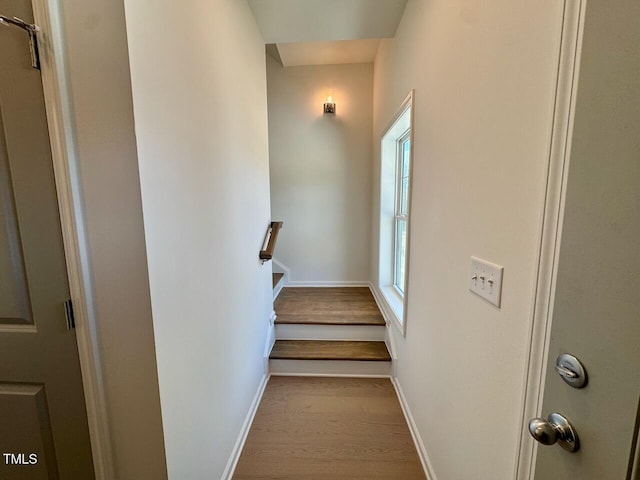 stairway featuring baseboards and wood finished floors