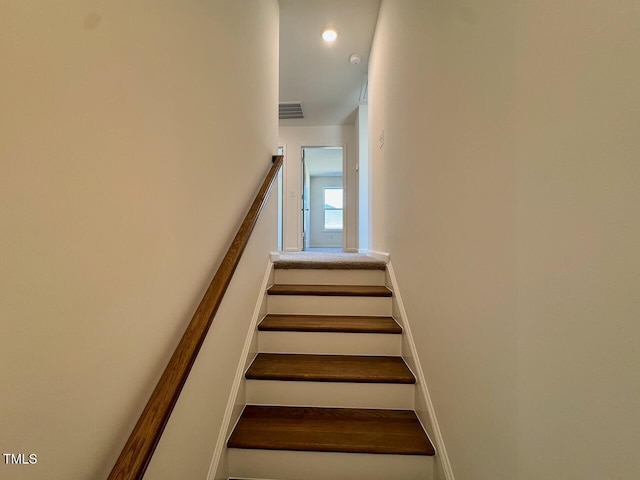 stairway with baseboards, visible vents, and recessed lighting