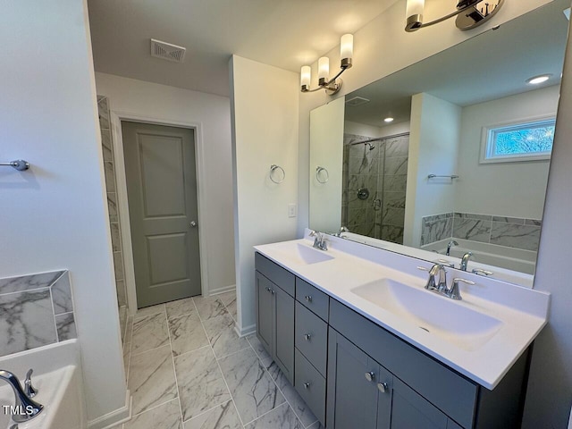 bathroom with marble finish floor, a garden tub, visible vents, a sink, and a shower stall