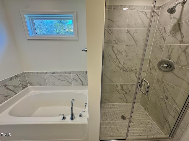 full bath featuring a shower stall and a bath