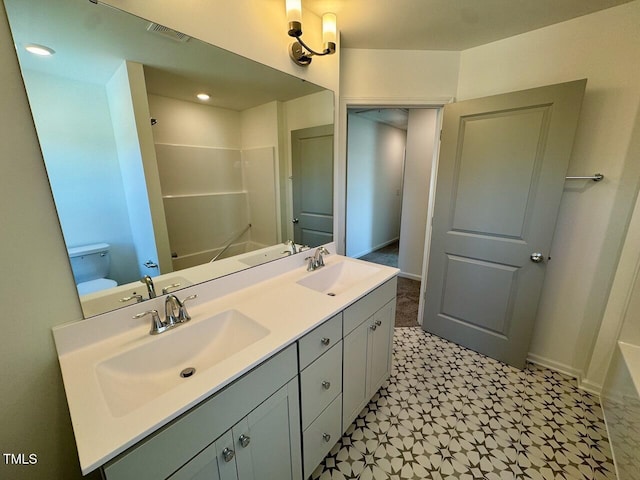 full bath with double vanity, a shower, a sink, and tile patterned floors