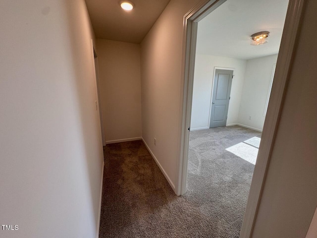 hall with carpet floors and baseboards