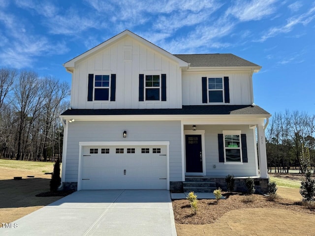 view of front facade with an attached garage, covered porch, board and batten siding, and concrete driveway