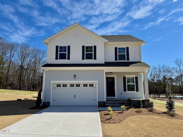 view of front of property with board and batten siding, covered porch, driveway, and an attached garage