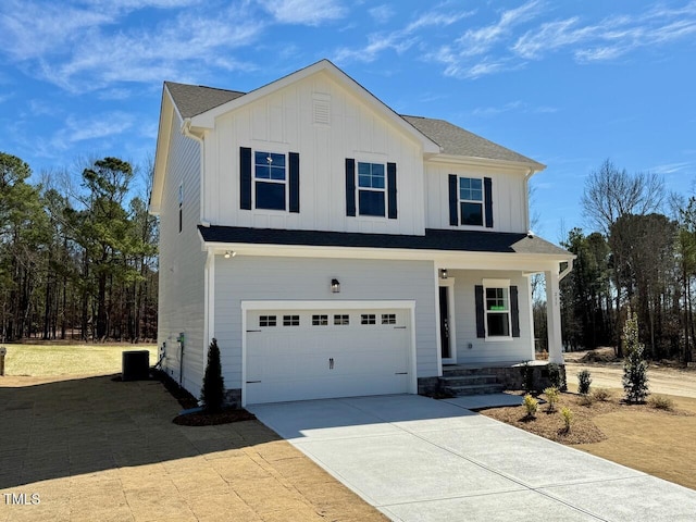 view of front facade with driveway, a garage, central air condition unit, a porch, and board and batten siding