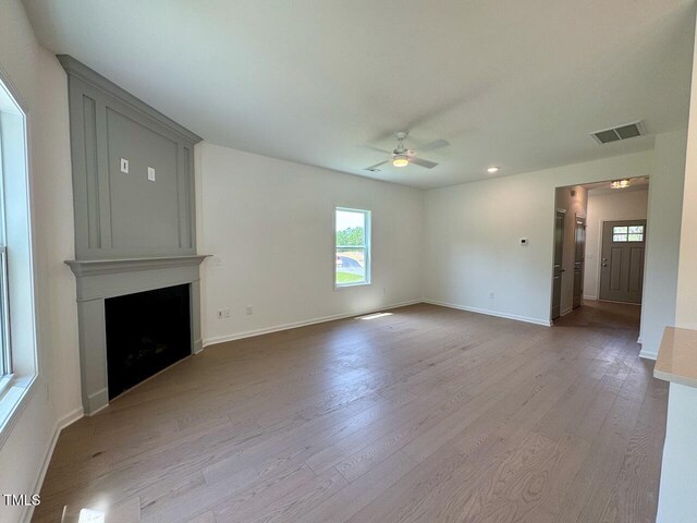 235 Grand Griffon Way, Lillington, NC 27546 - unfurnished living room with ceiling fan, healthy amount of natural light, wood finished floors, baseboards, and recessed lighting