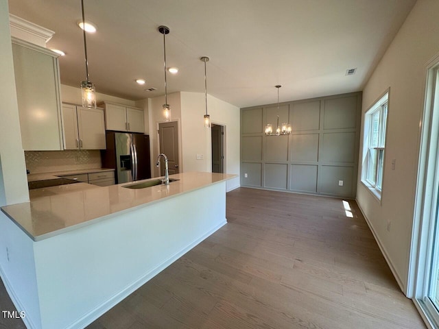 235 Grand Griffon Way, Lillington, NC 27546 - kitchen featuring a sink, a chandelier, light wood-style floors, stainless steel fridge, and recessed lighting