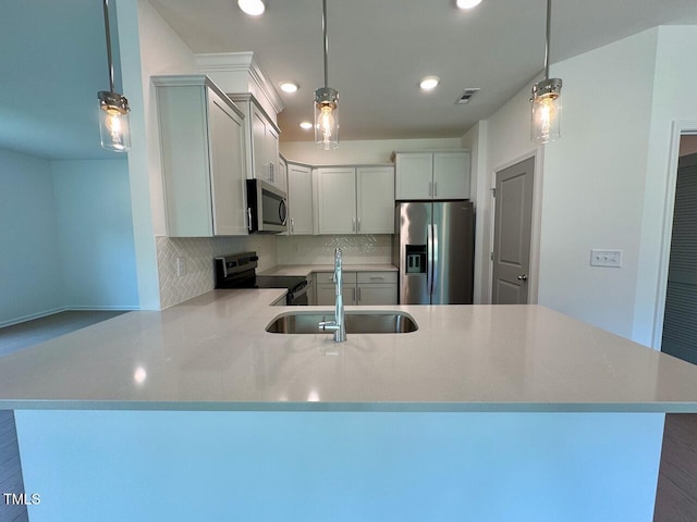 235 Grand Griffon Way, Lillington, NC 27546 - kitchen featuring appliances with stainless steel finishes, a sink, a peninsula, backsplash, and recessed lighting