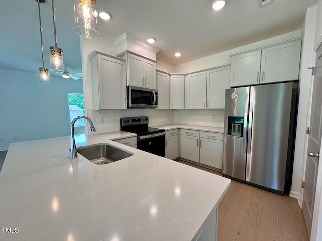 235 Grand Griffon Way, Lillington, NC 27546 - kitchen with stainless steel appliances, a sink, backsplash, decorative light fixtures, and recessed lighting