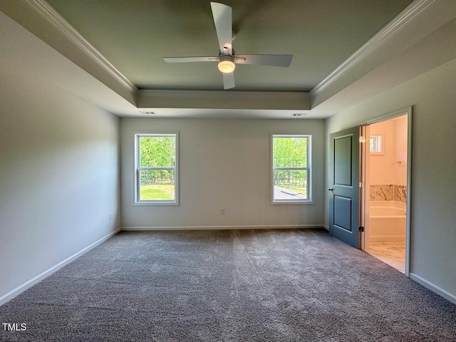 235 Grand Griffon Way, Lillington, NC 27546 - unfurnished bedroom featuring ornamental molding, a raised ceiling, carpet flooring, and multiple windows