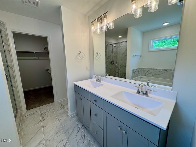 235 Grand Griffon Way, Lillington, NC 27546 - bathroom with a shower stall, a walk in closet, marble look tile flooring, baseboards, and double vanity