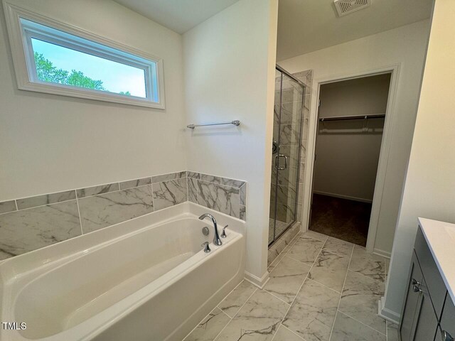 235 Grand Griffon Way, Lillington, NC 27546 - bathroom featuring marble look tile flooring, vanity, a bath, and a shower stall