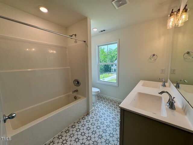 235 Grand Griffon Way, Lillington, NC 27546 - full bath with toilet, tile patterned floors, double vanity, washtub / shower combination, and baseboards