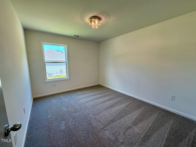 235 Grand Griffon Way, Lillington, NC 27546 - carpeted spare room with baseboards