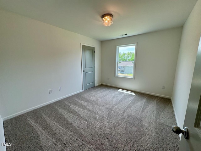 235 Grand Griffon Way, Lillington, NC 27546 - spare room featuring baseboards and carpet flooring