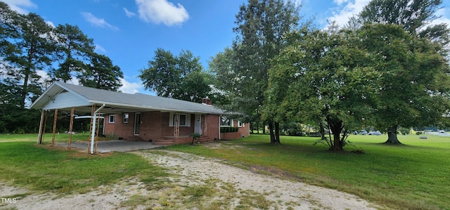 view of front of home with a front lawn and a carport