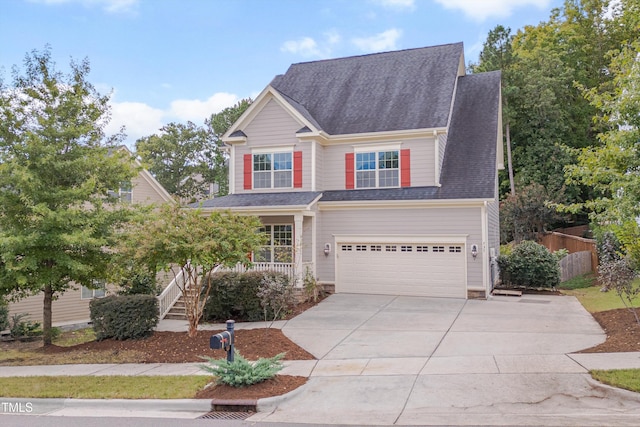 traditional home with roof with shingles, a porch, concrete driveway, stairway, and an attached garage