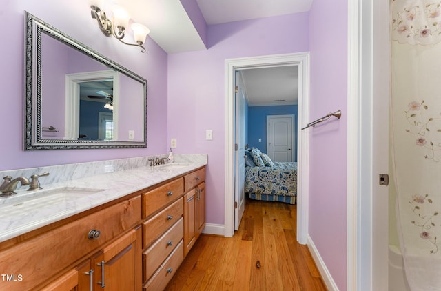 bathroom with hardwood / wood-style floors, vanity, a shower, ceiling fan, and ornamental molding
