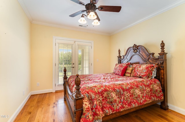 bedroom featuring hardwood / wood-style floors, ceiling fan, ornamental molding, and french doors