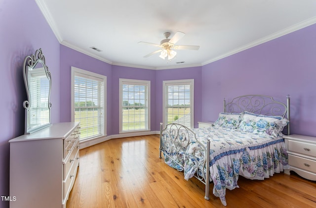 bedroom featuring ceiling fan, crown molding, and light wood-type flooring