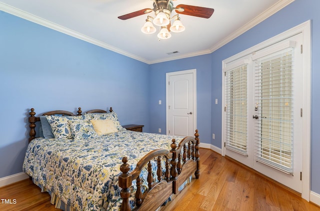 bedroom with crown molding, light hardwood / wood-style flooring, and ceiling fan