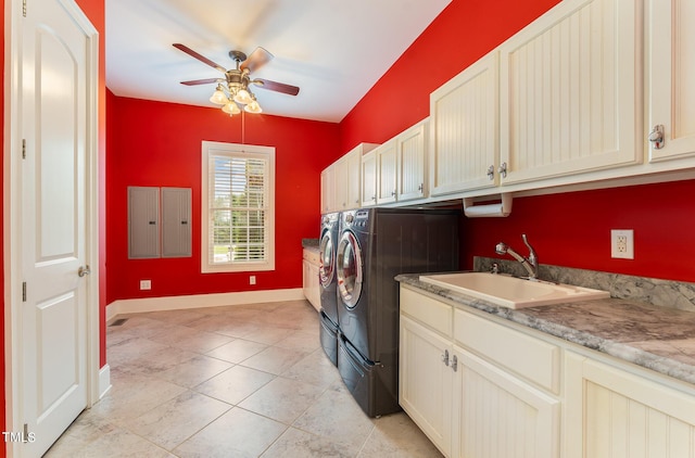 laundry area with ceiling fan, sink, cabinets, separate washer and dryer, and light tile patterned floors