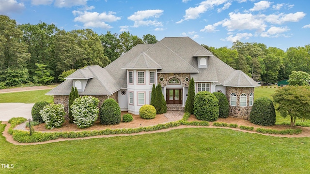 view of front of house with a front lawn and french doors