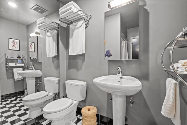 bathroom with toilet, tile patterned floors, and visible vents