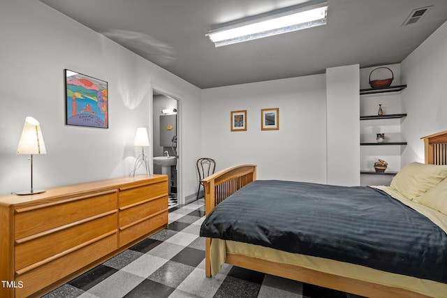 bedroom featuring dark floors and visible vents