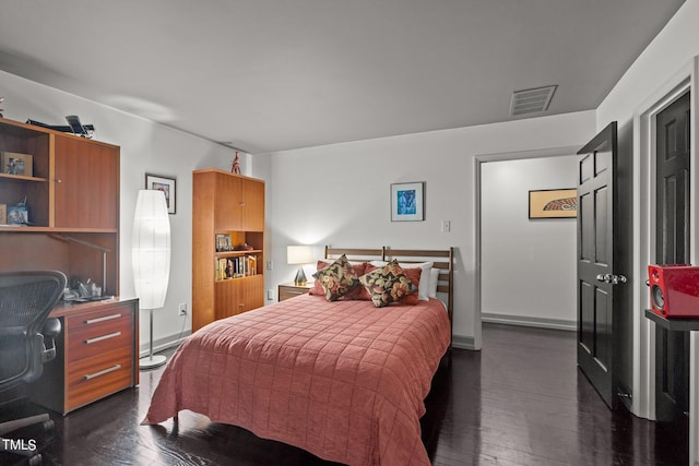 bedroom with dark wood-type flooring and visible vents