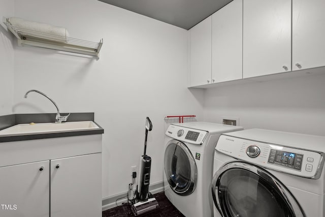 washroom with cabinets, separate washer and dryer, and sink