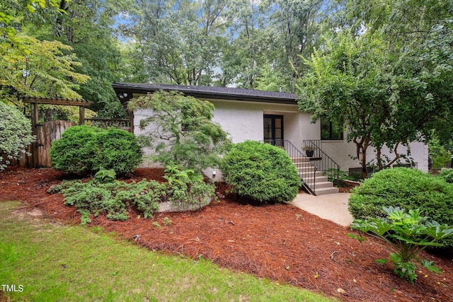 view of front of home featuring fence and brick siding