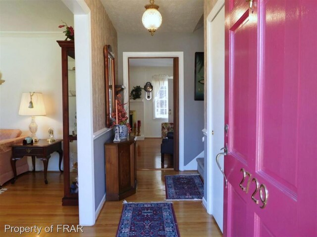 entryway featuring a textured ceiling and light wood-type flooring