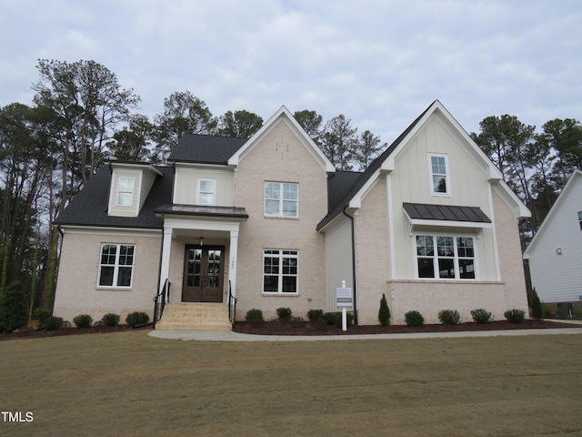 view of front of house featuring french doors and a front lawn