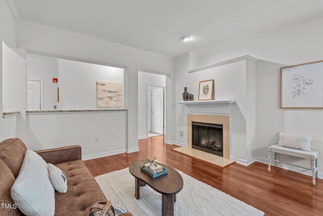 living room featuring ornamental molding and wood-type flooring