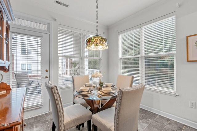 tiled dining space featuring ornamental molding