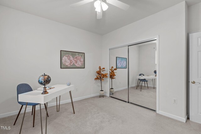 office space with ceiling fan and light colored carpet