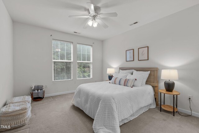 bedroom with light carpet and ceiling fan